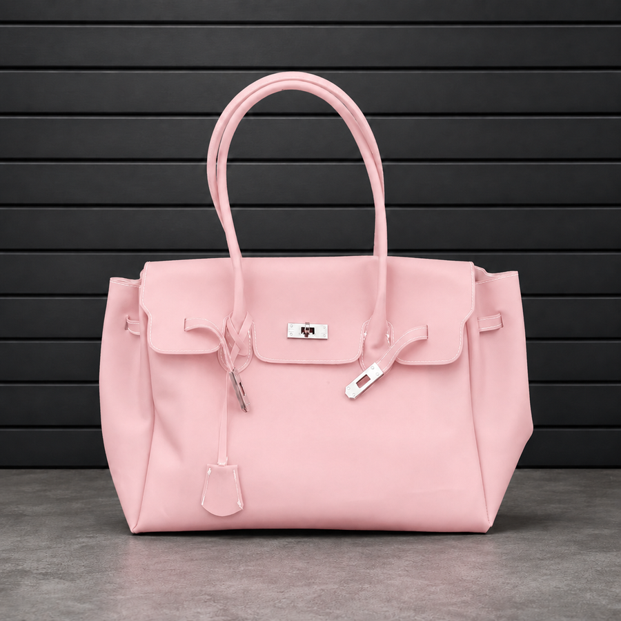 Sac à main Jelly Firkin Blush en PVC effet gelée rose poudré, fermoir cadenas argenté et anses rondes surpiquées