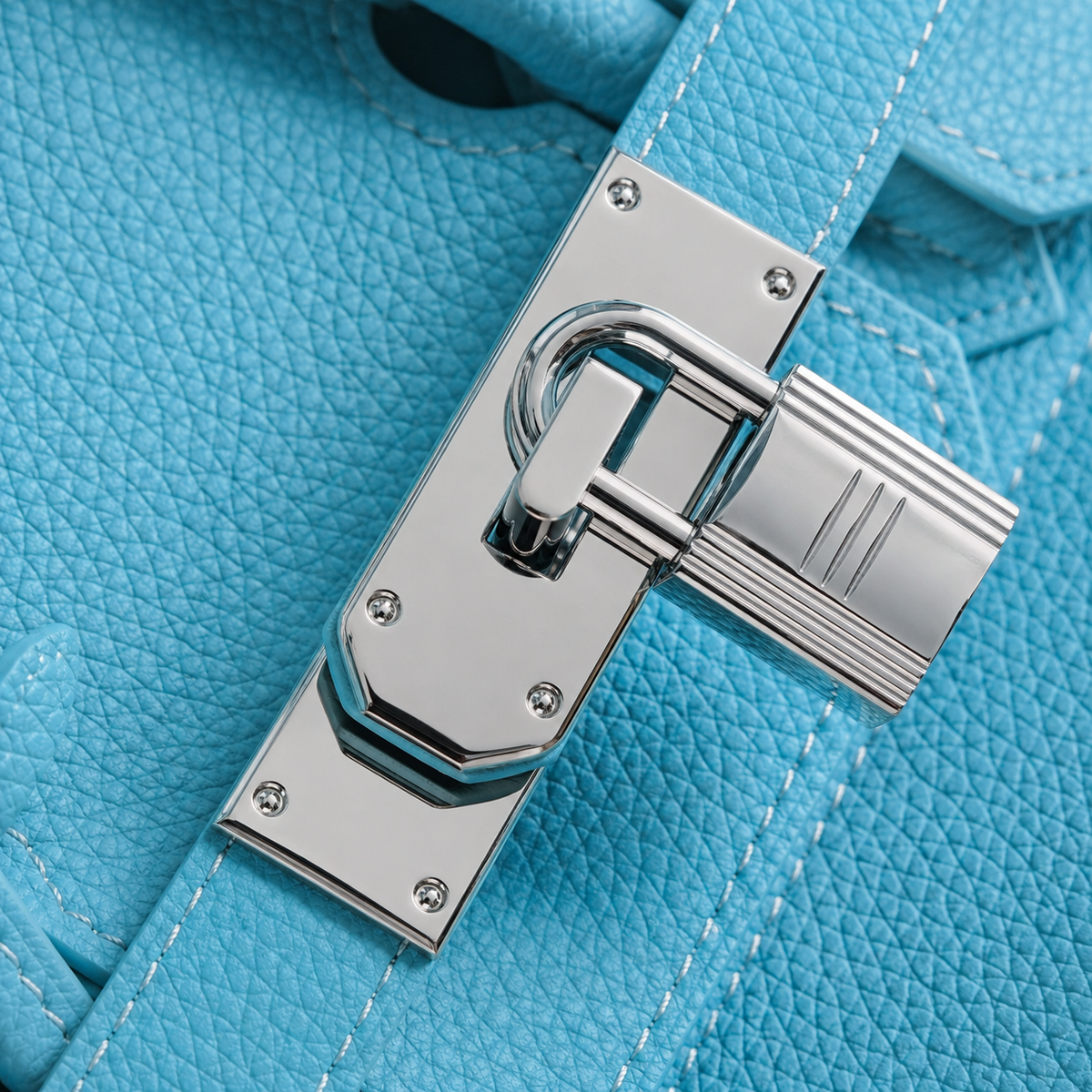 Gros plan sur le fermoir cadenas argenté du sac Jelly Élan Celeste en cuir grainé
